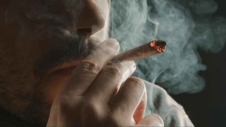 man smoking a legal cannabis joint