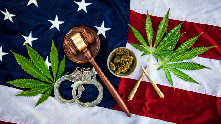 marijuana, handcuffs, and a gavel on an American flag