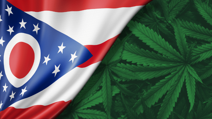 The flag of Ohio pulls back to reveal marijuana leaves