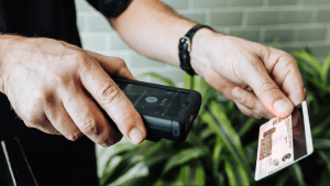 a cannabis dispensary employee scans an ID to verify the customer's age